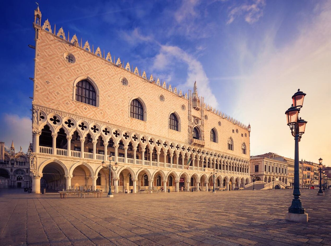 Palace facade at sunrise with lamp posts on Piazzetta San Marco